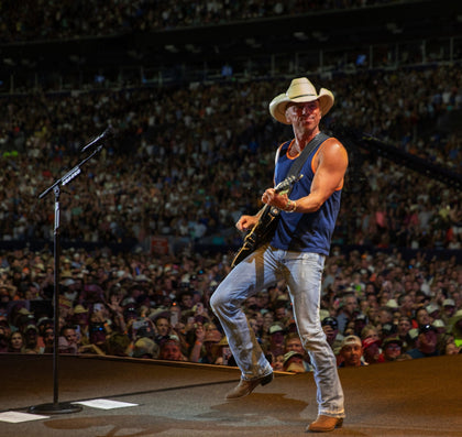Kenny Chesney on stage playing guitar